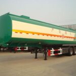 Front three-quarter view of a green and cream tanker trailer