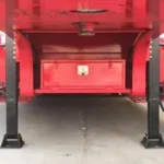 Front landing legs and toolbox below a red trailer