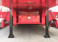 Front landing legs and toolbox below a red trailer
