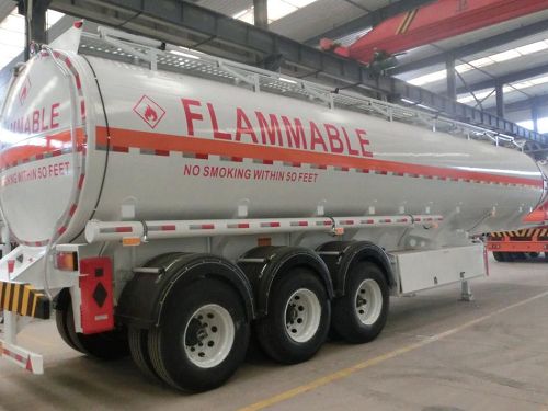 Silver tanker marked Flammable inside a workshop
