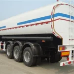 White tanker with blue and red stripes viewed from the rear side