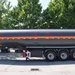 Side profile of a tanker on a red chassis