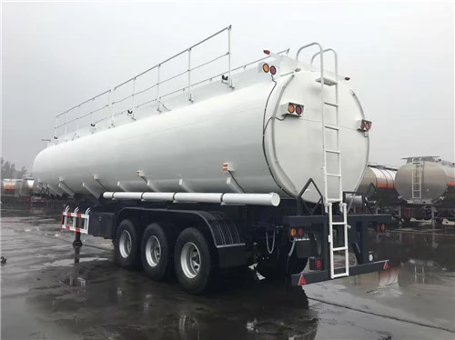 White tanker trailer with rear equipment and three axles