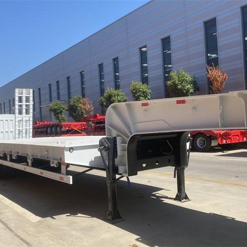 Lowbed trailer platform and front gooseneck outside a workshop