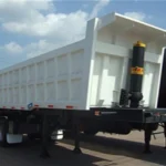 White dump trailer with the rear discharge door visible