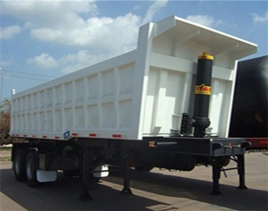 White dump trailer with the rear discharge door visible
