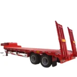 Red lowbed trailer with two upright rear ramps