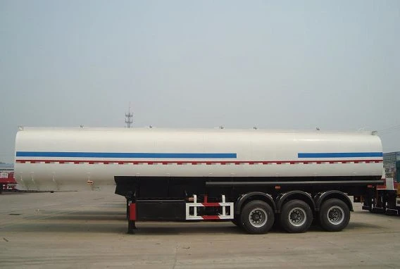 Side view of a white tanker with blue and red stripes