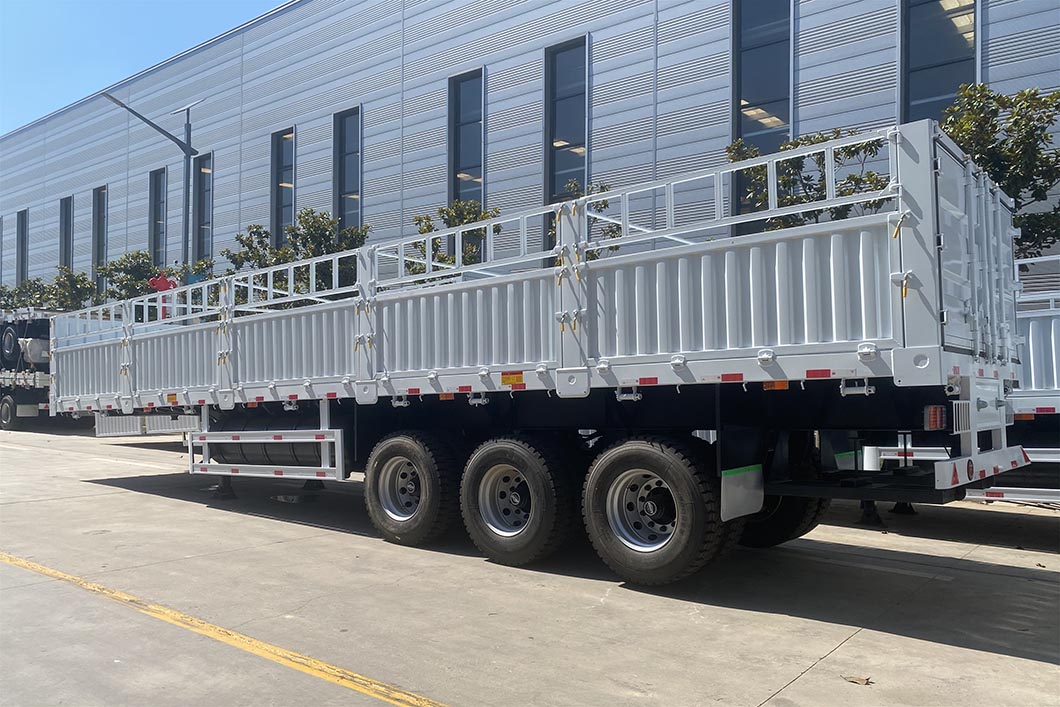 The vehicle type and fence structure design process is combined with the user's cargo category. The design is well thought out to fully reduce the weight of the carriage under the load conditions. The structure is simple and applicable and the disassembly is convenient, which reduces investment costs for users and create more profit value. The frame structure of cargo fence trailer is formed by welding longitudinal beams and integral penetrating beams. It can balance the strength, stiffness and toughness of the frame with strong bearing capacity and no deformation. The series of cargo fence semi-trailer frames are all beam type structures. The longitudinal beams are either straight type or gooseneck type. The height of the web is from 400 to 500. The longitudinal beam is welded by automatic submerged arc welding. The entire frame is processed by shot blasting. The cross beam penetrates the longitudinal beam and is welded as a whole.