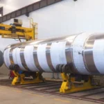 Tank sections on assembly supports inside a workshop