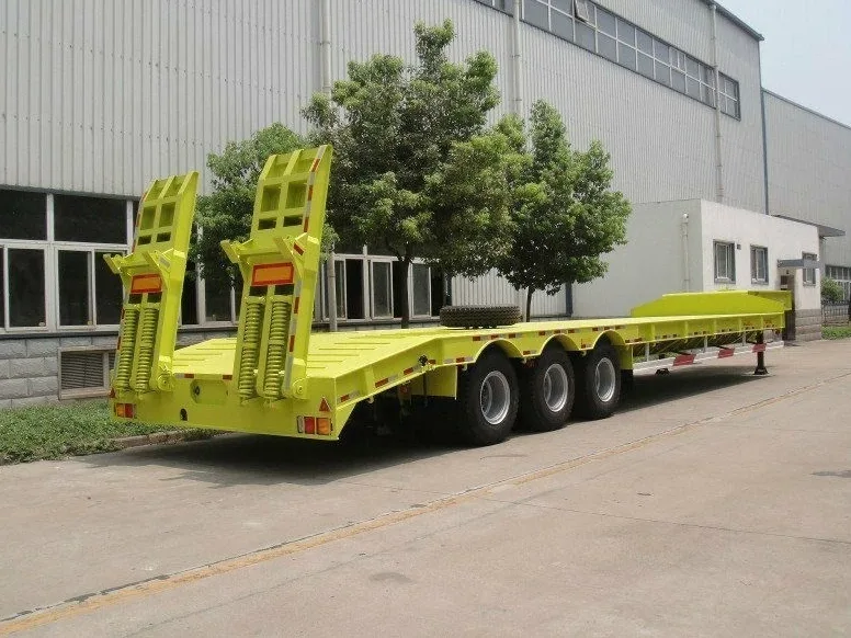 Drop deck and double drop flatbed trailer with low deck height loading an excavator